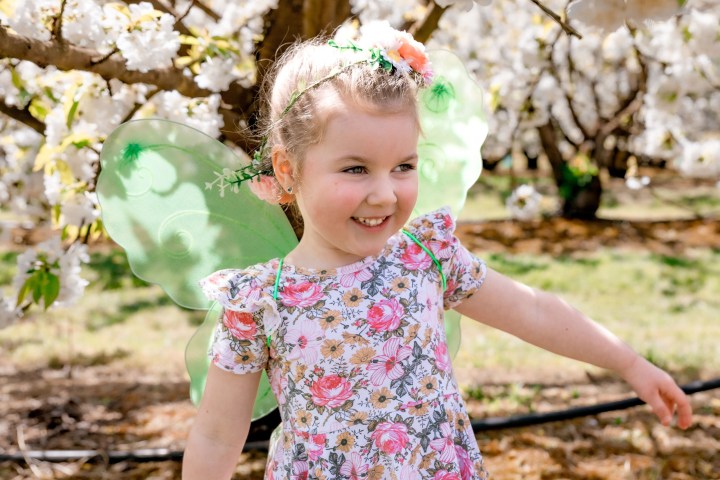 a little girl holding a baby