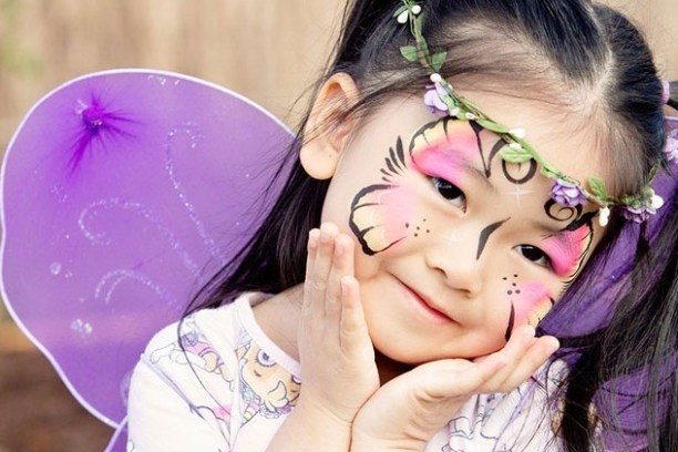 a little girl that is holding a pink umbrella