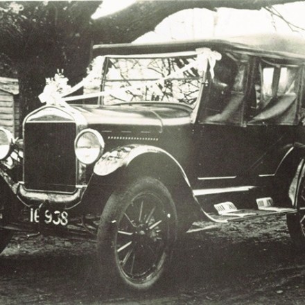a vintage photo of a man driving a car